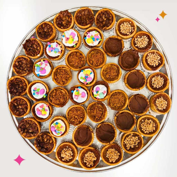 Close-up of mini butter tarts on a tray, highlighting flaky crusts and glossy filling, perfect for events and easy self-serve